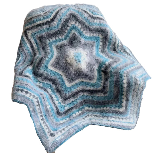 Star-shaped knitted blanket in blue and gray on a chair