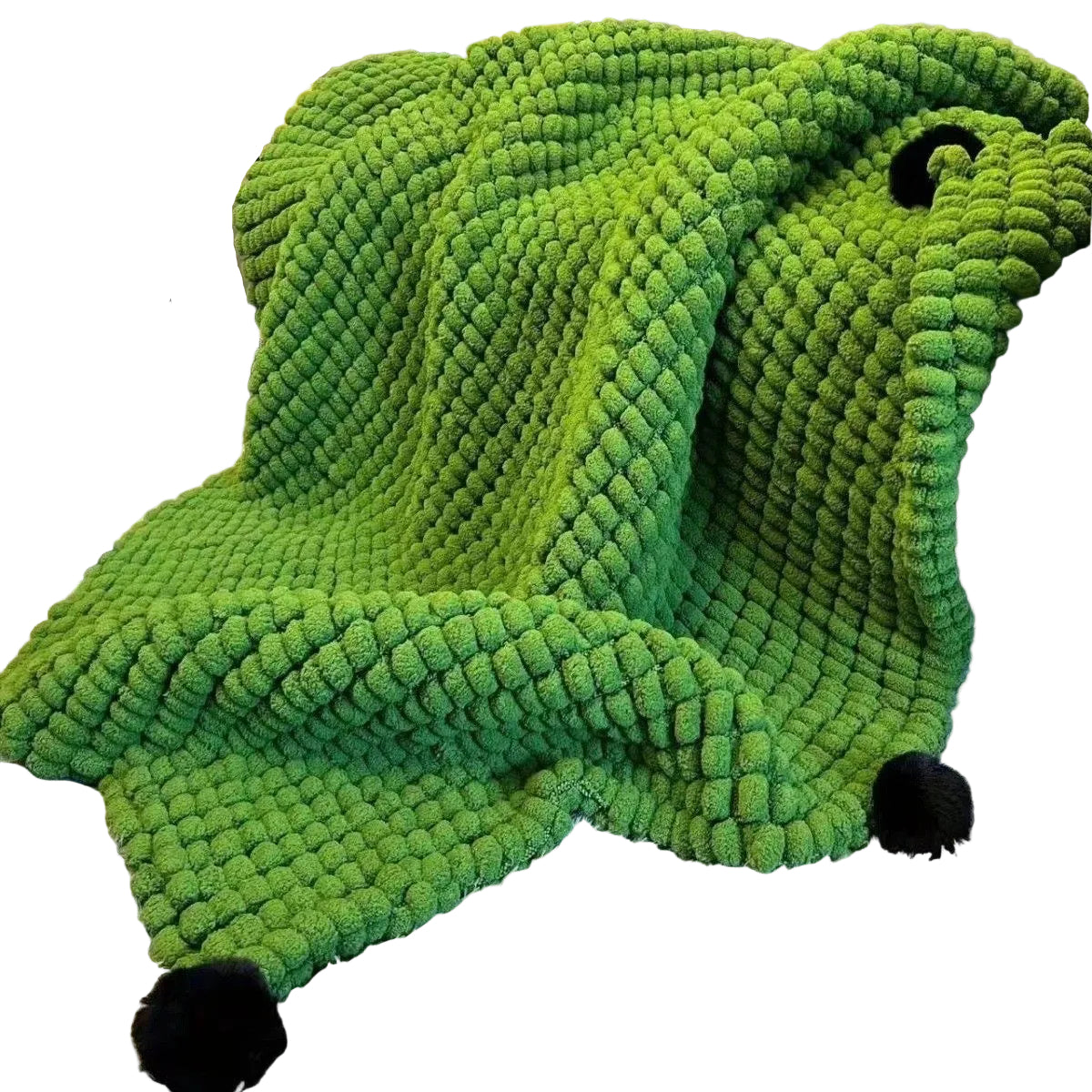 Green textured blanket draped over a chair in a living room setting