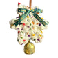 Decorative wreath with a gold bell and green ribbon in front of a laptop screen.
