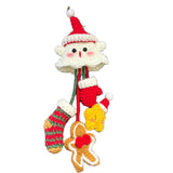Christmas-themed keychain with Santa Claus design on a dark fabric background