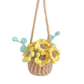 Crocheted flower basket with yellow flowers and green leaves on a white background