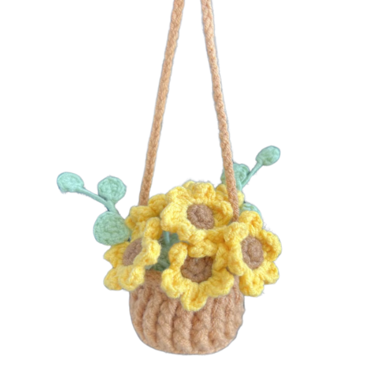 Crocheted flower basket with yellow flowers and green leaves on a white background