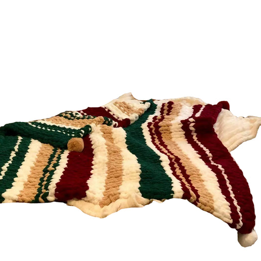 Bed with striped bedding, colorful blanket, and various pillows including a dog pillow.