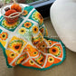 Crocheted blanket with sunflower pattern on a car seat