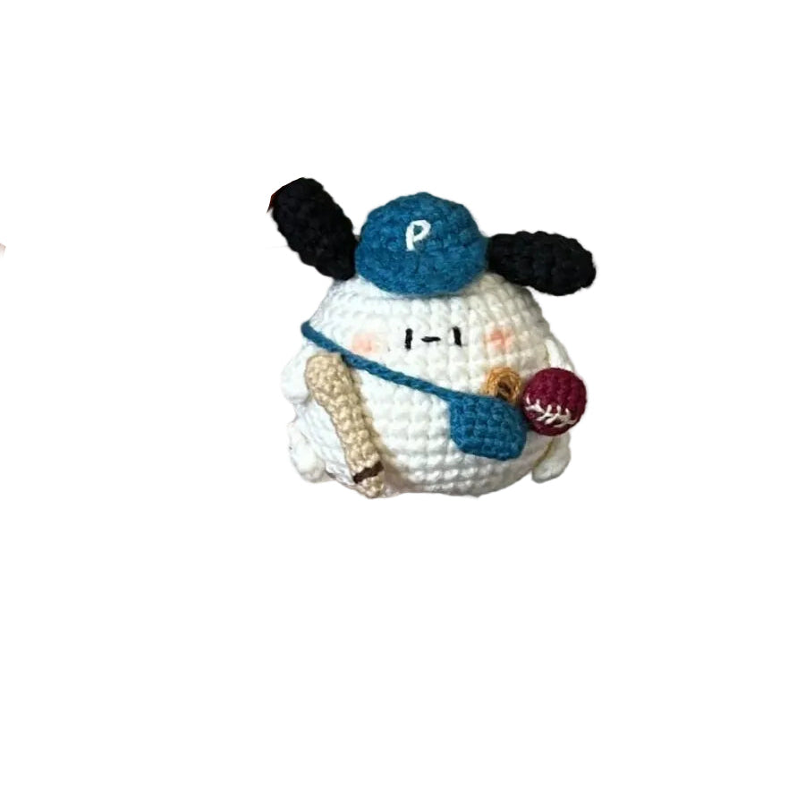 Hand holding a small crocheted snowman toy with a plain background