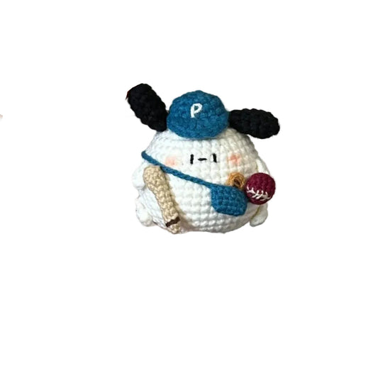 Hand holding a small crocheted snowman toy with a plain background