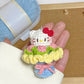 Hand holding a small crocheted character with yarn in the background