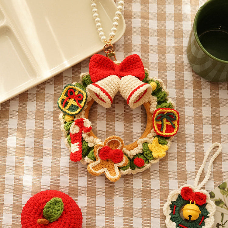 Decorative Christmas wreath ornament with gingerbread men on a checkered tablecloth.