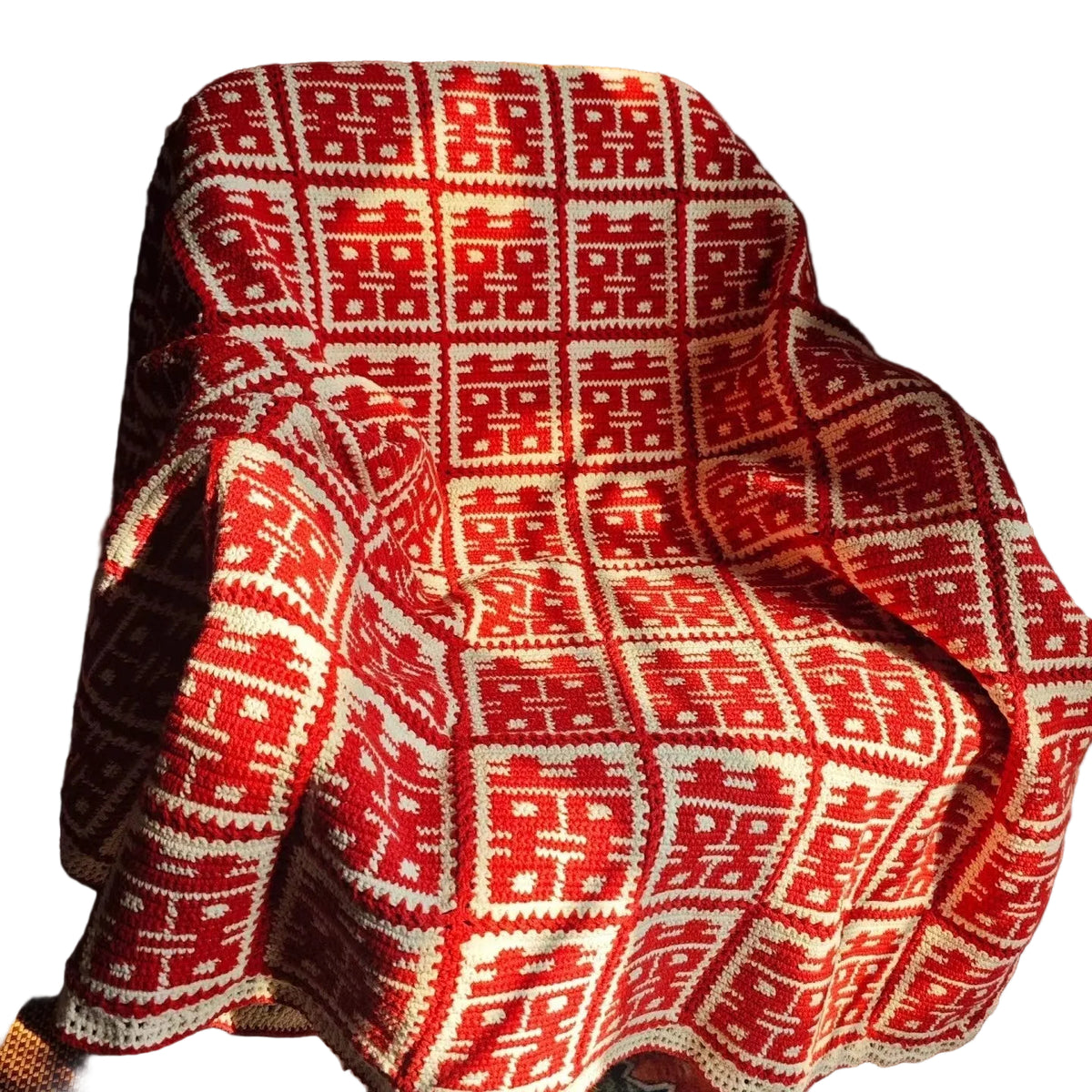 Red and white patterned blanket draped over a chair
