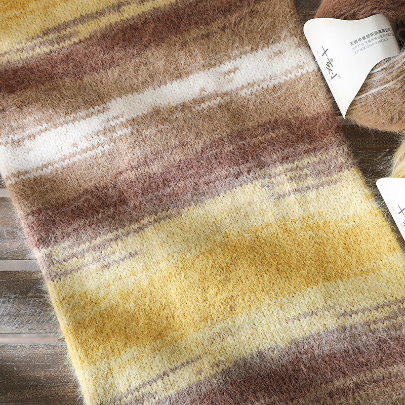 Striped fabric with brown, yellow, and white colors on a wooden surface.