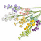 A set of artificial flower stems arranged diagonally on a white background, featuring small clustered blossoms in purple, white, pink, yellow, and light green.