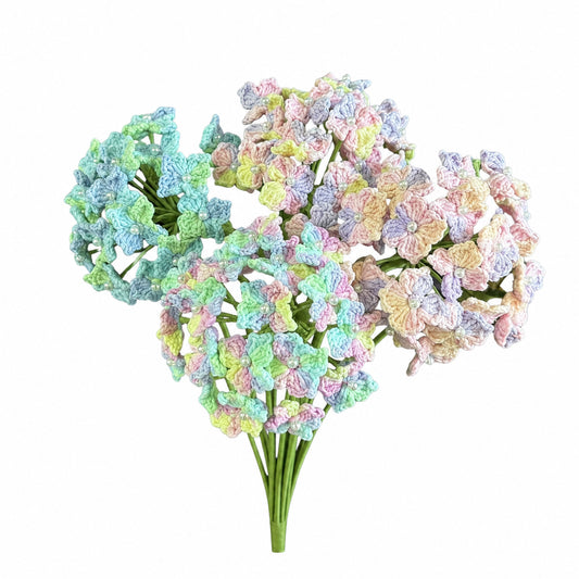 A bouquet of artificial pastel hydrangea-style flower heads on green stems, photographed against a plain white background.