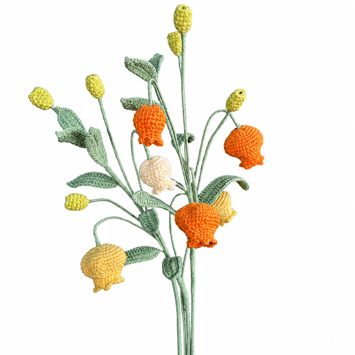 Crocheted flowers in orange, yellow, and green on a white background