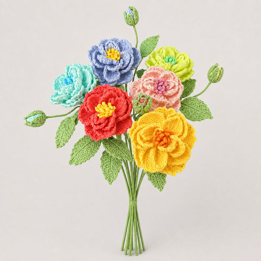 A handmade crochet flower bouquet with multiple colorful blooms and green leaves, arranged in a bundle of stems against a plain light gray background.