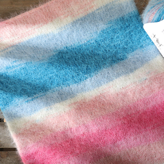 Multicolored fabric with pink, blue, and white stripes on a wooden surface.