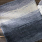 Textured fabric with blue and gray gradient on a wooden surface