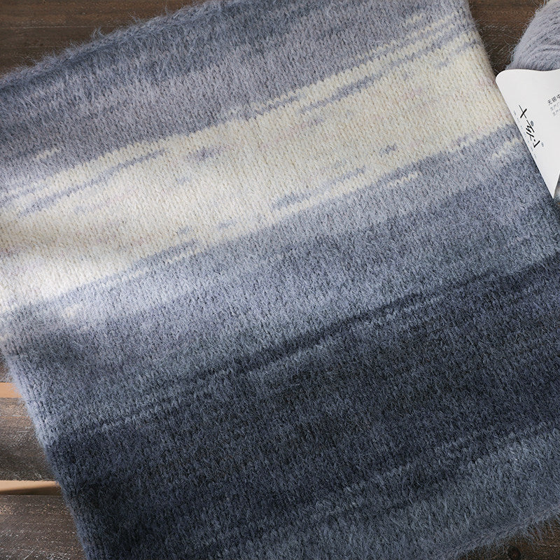 Textured fabric with blue and gray gradient on a wooden surface