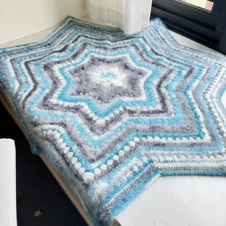 Knitted blanket with a geometric pattern on a bed
