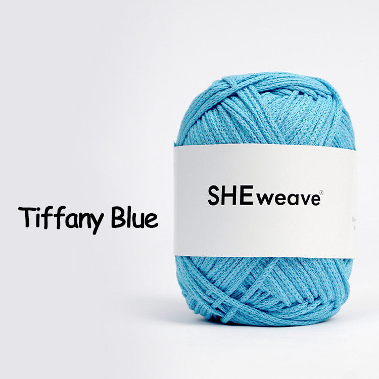 Blue yarn ball with 'SHEweave' label on a white background