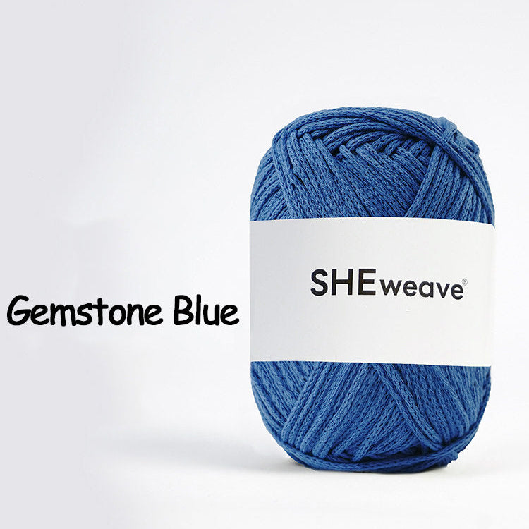 Blue yarn ball with a white label on a white background