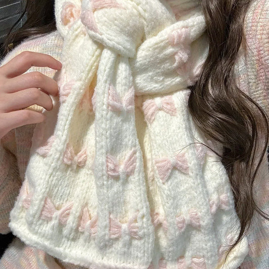 Person wearing a white knitted scarf with pink butterfly patterns