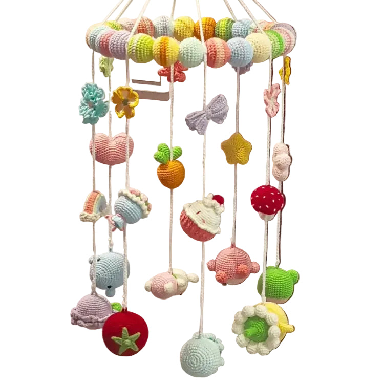 Colorful crochet baby mobile hanging on a door