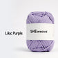 Lilac purple yarn ball with 'SHEweave' label on a white background
