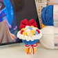 Colorful knitted flower bouquet in front of a laptop displaying an animated character.