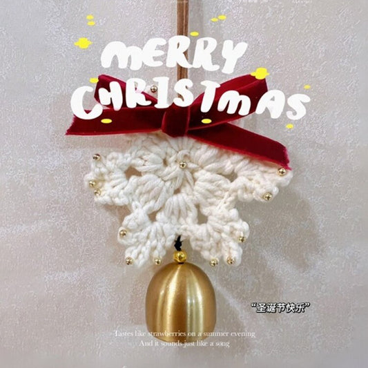 Decorative Christmas ornament with a red bow and gold bell on a textured white background.