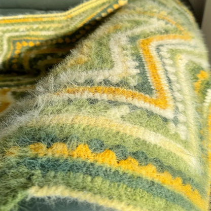 Close-up of a textured fabric with green and yellow patterns